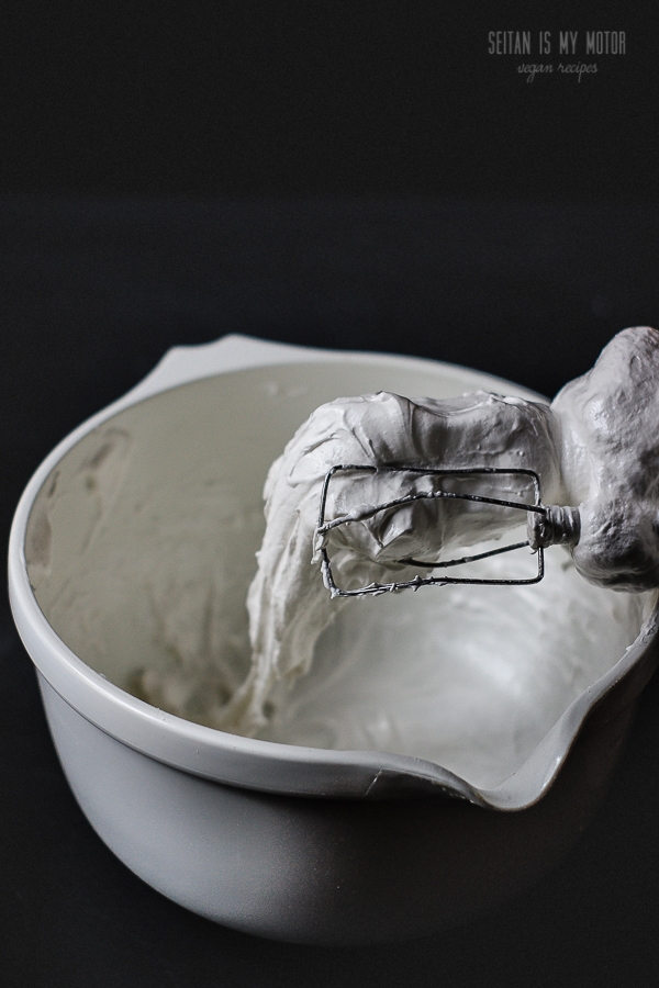 Vegan marshmallow fluff in a bowl and on a handheld mixer.