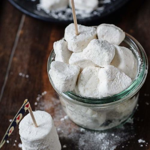 A bunch of vegan marshmallows in a jar.
