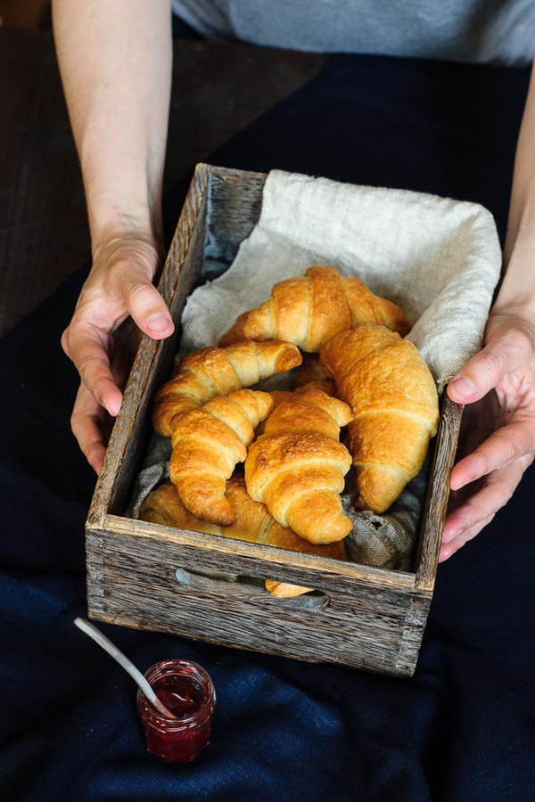 A batch of vegan croissants in a wooden box