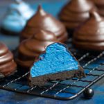 chocolate covered marshmallow treats cut open to reveal the blie colour.