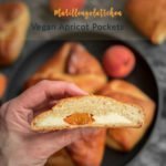 An apricot kolach cut open to show the cream cheese filling.
