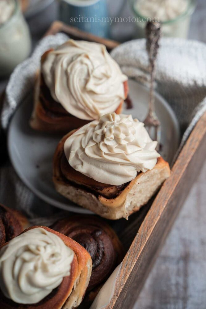 Vegan whipped cream substitute piped on top of a batch of chocolate rolls.