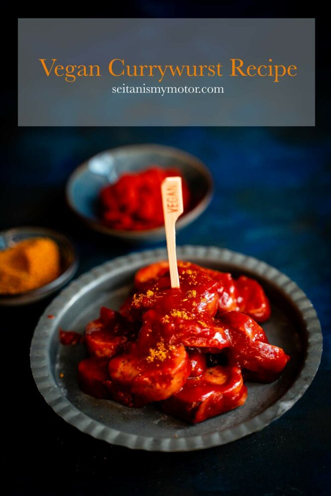 A batch of seitan based German currywurst covered in curry ketchup sauce on a small plate.